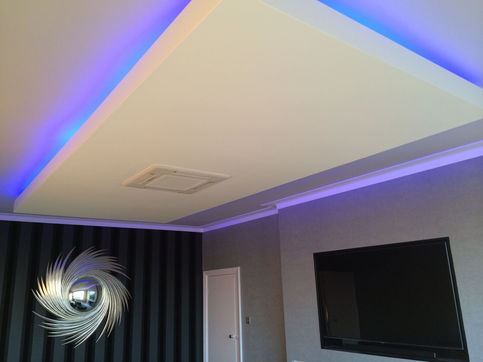 Ceiling cassette set into a lit feature ceiling