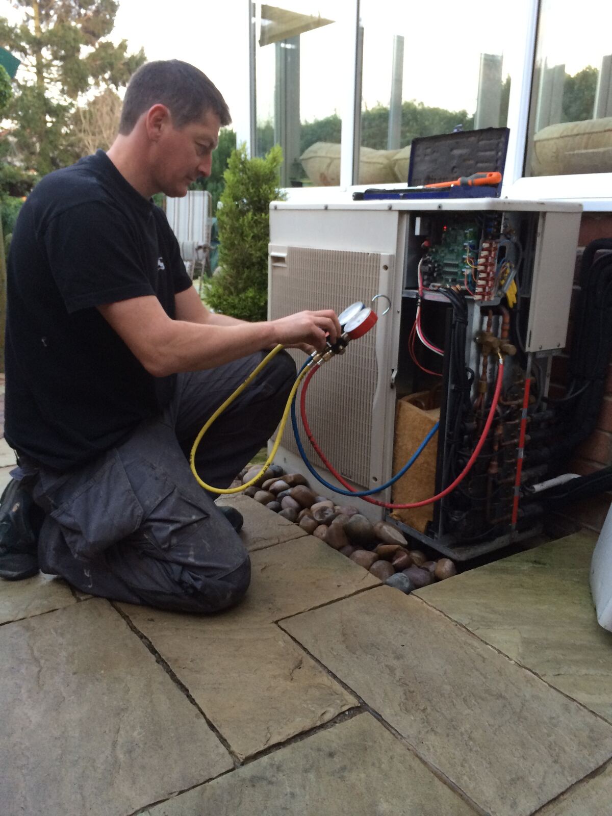 KSR engineer connecting refrigerant gauges to an outdoor unit