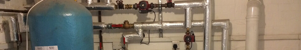 Domestic heating plant room with cylinder and insulated pipework