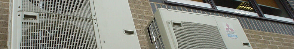 Mitsubishi outdoor heat pump units on a building